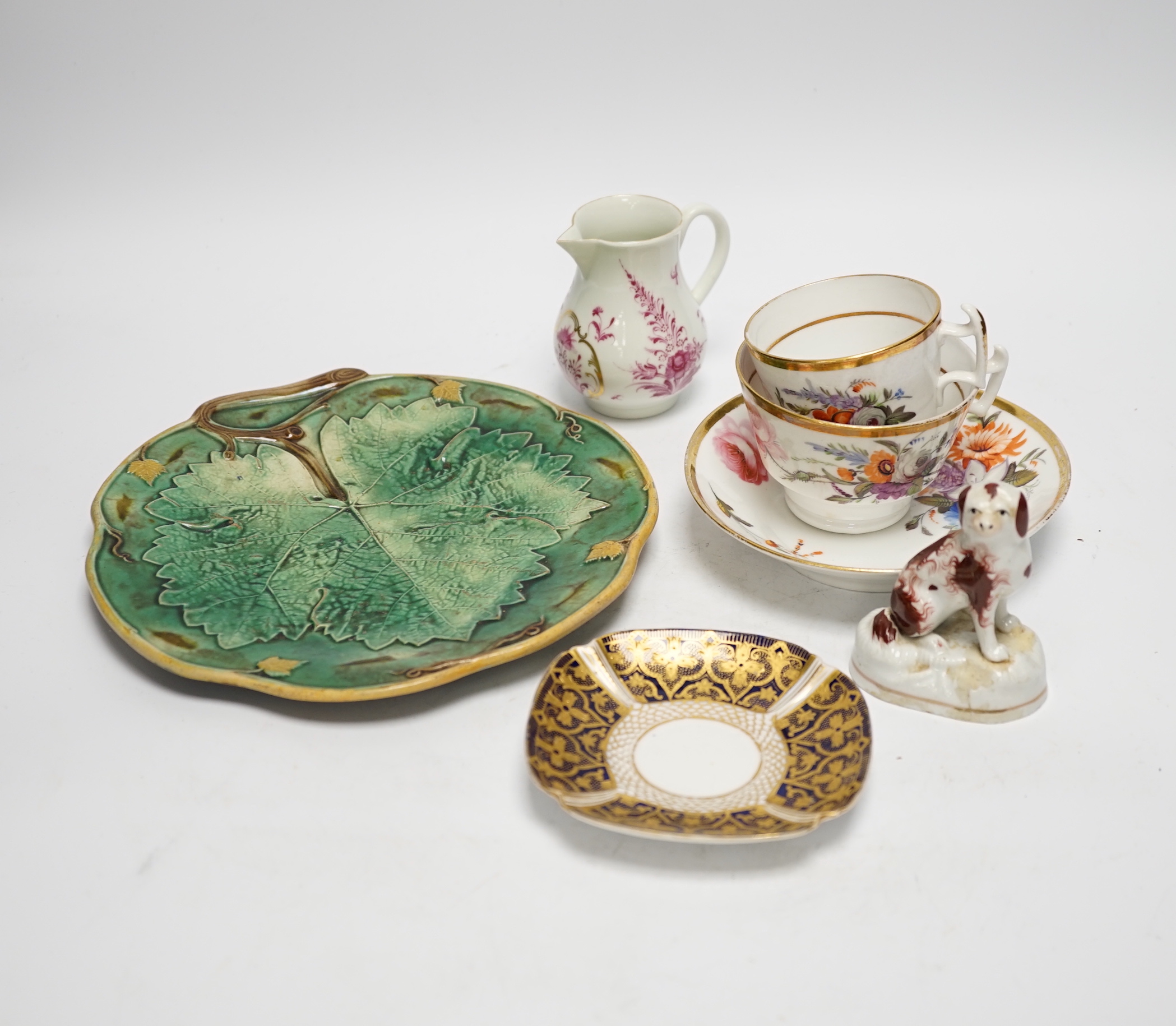 Continental porcelain: four putti ornaments, a Staffordshire dog, green leaf plate, a napkin ring 18th century jug etc (15)